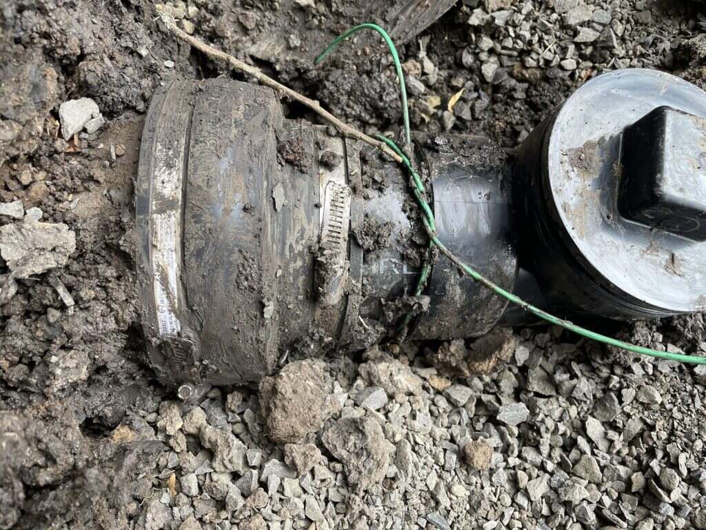 Heavily corroded pipe coupling excavated from the ground