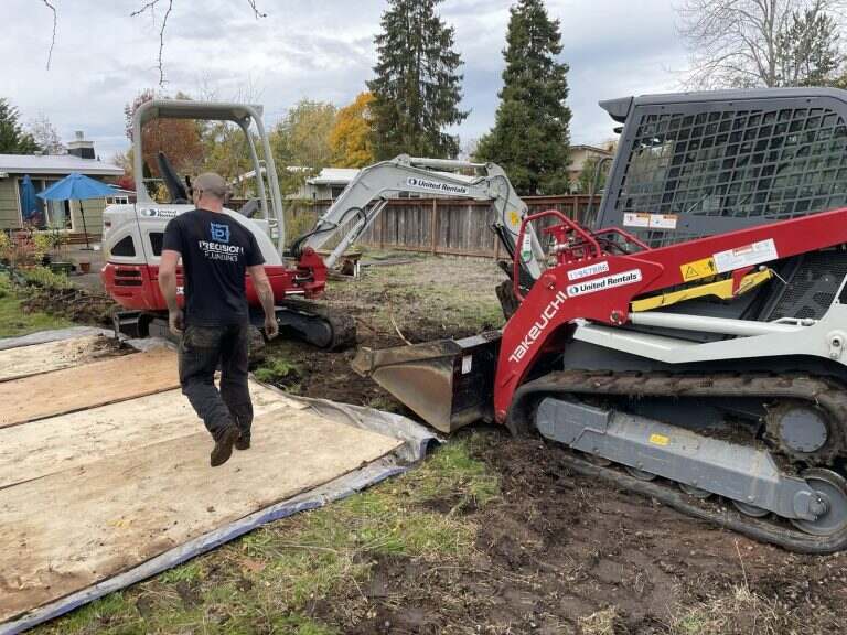 Excavation equipment on a Precision Plumbing sewer replacement job site
