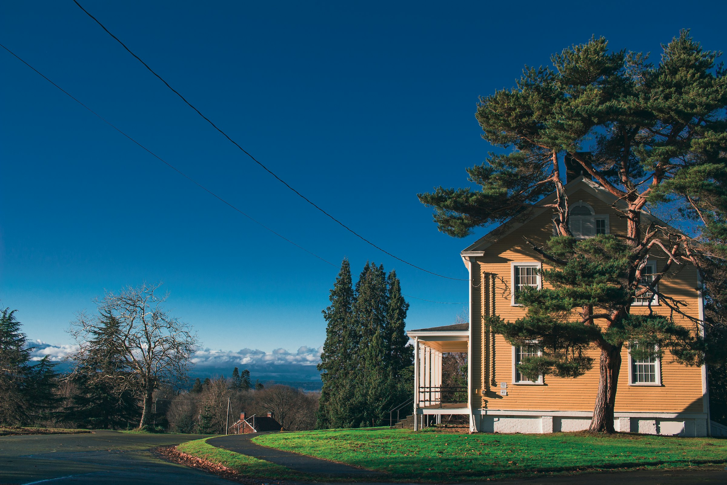 House with a lawn, evergreens, and a valley view