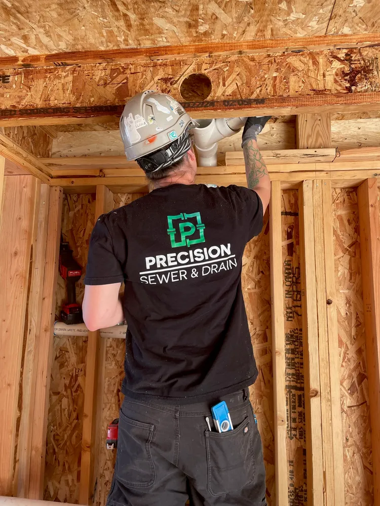Plumber fitting drain lines in new construction