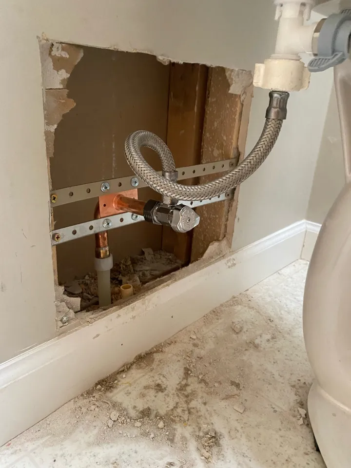 Drain piping exposed under a fixture during diagnosis