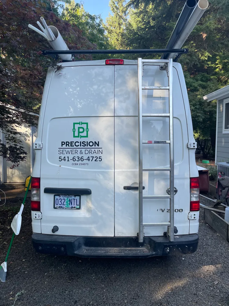 Rear of a Precision Plumbing service van