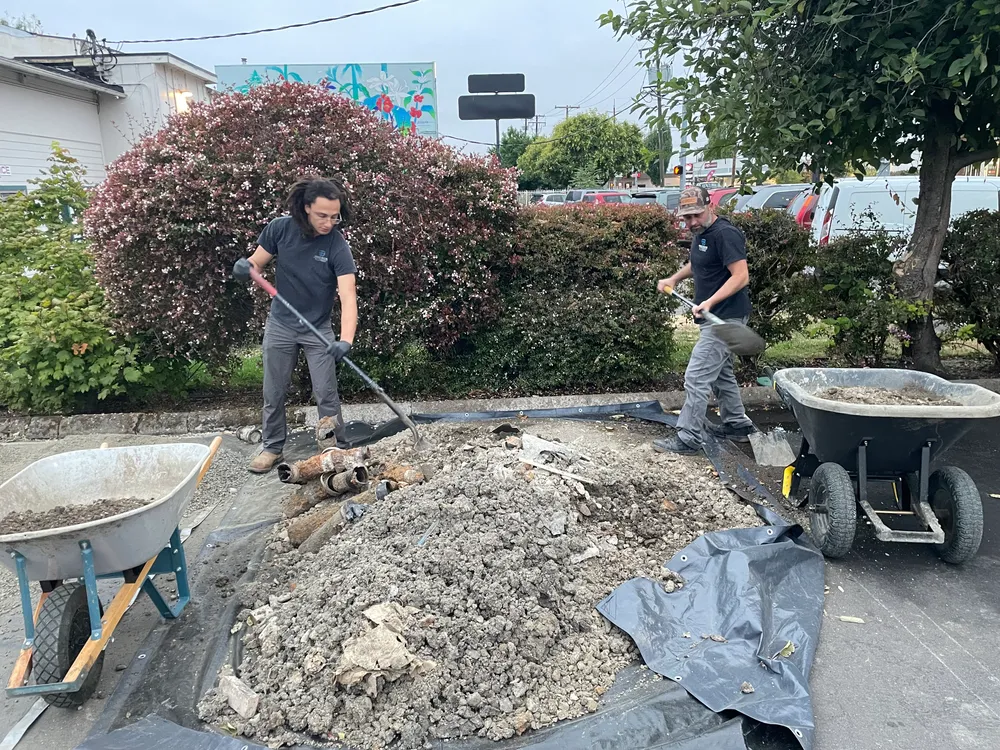 Wheelbarrow and trench during a water line repair