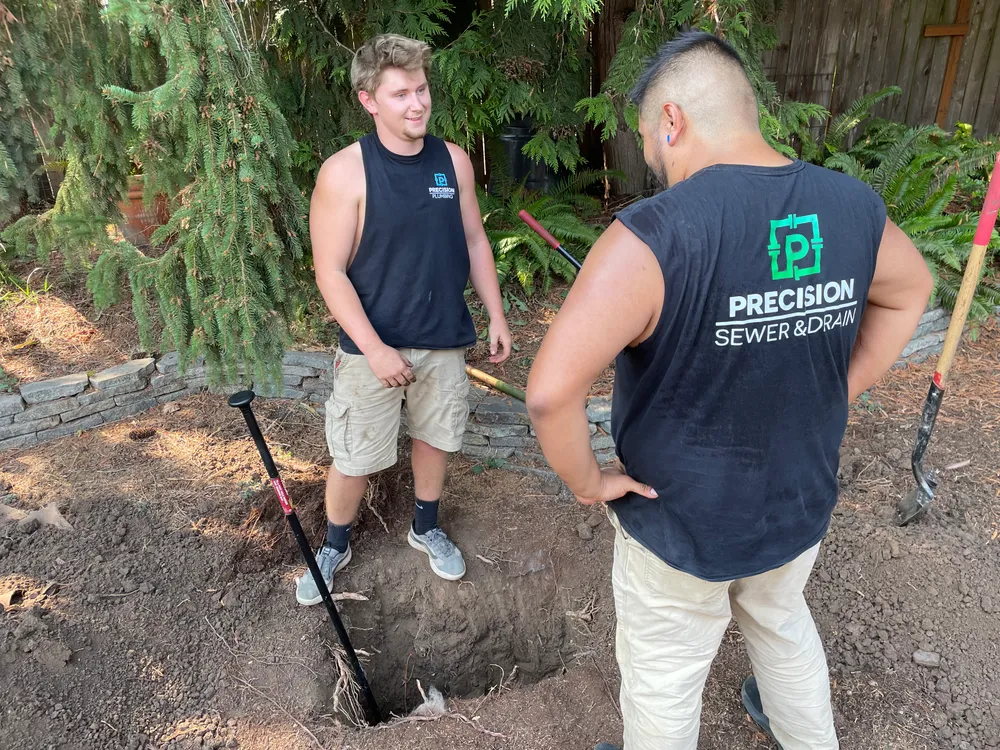 Technicians working in a water line trench