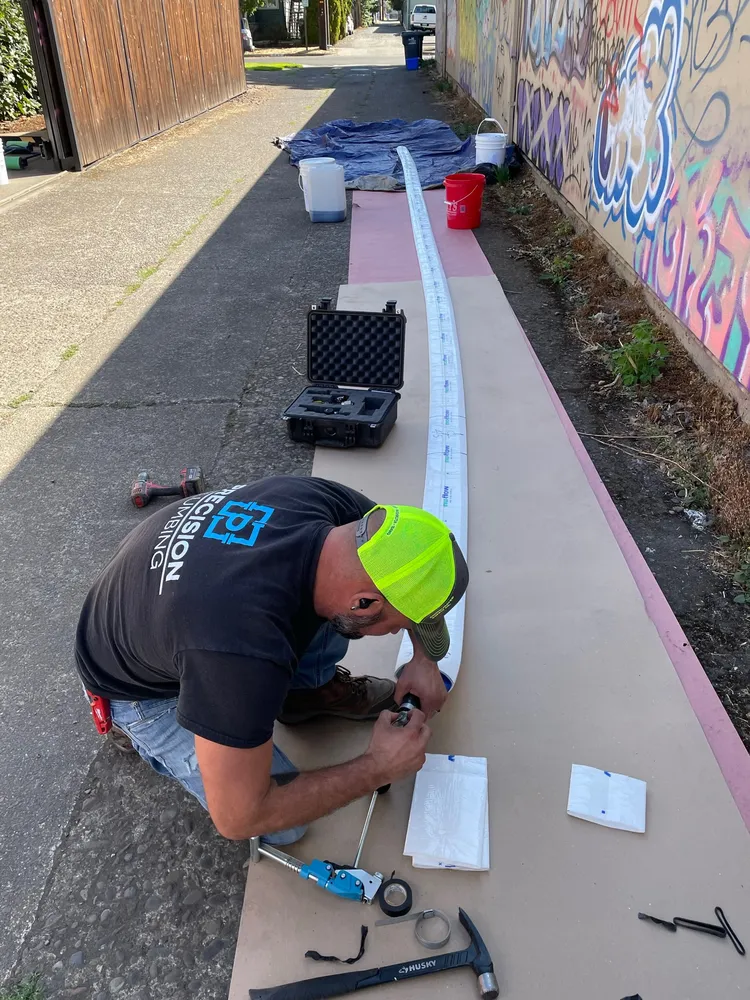 Precision Plumbing technician working an outdoor repair