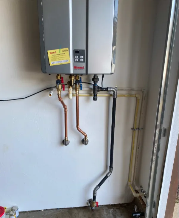 Wall-mounted Rinnai tankless water heater with copper connections
