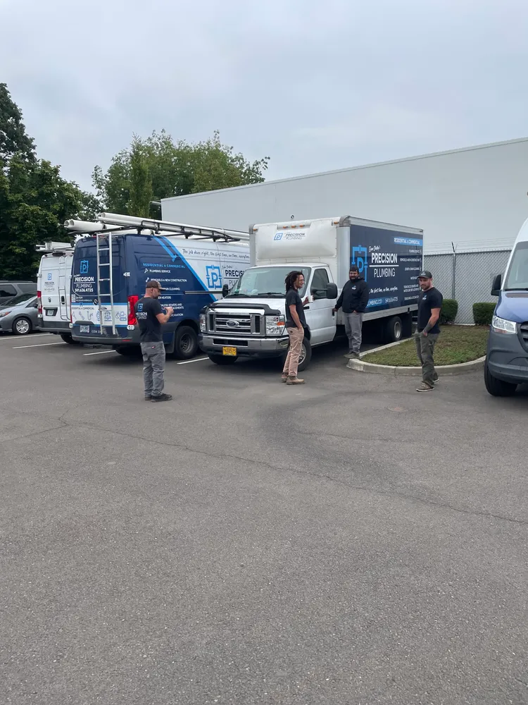 A line of Precision Plumbing trucks ready to roll