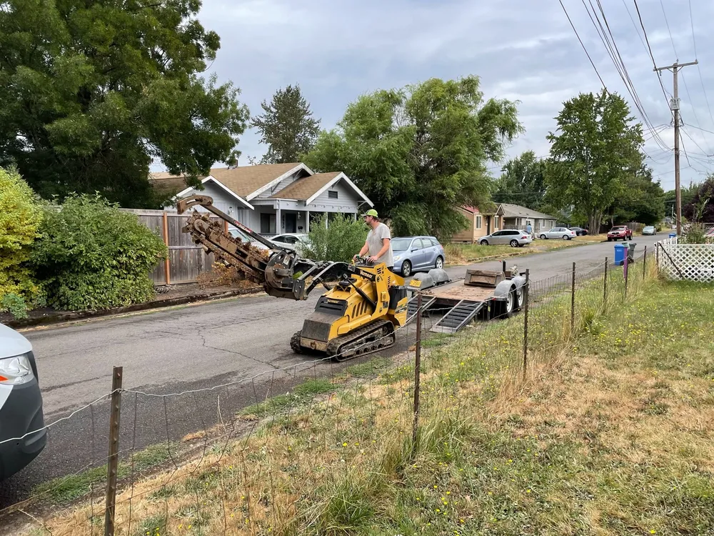 Excavator opening the ground for a sewer repair