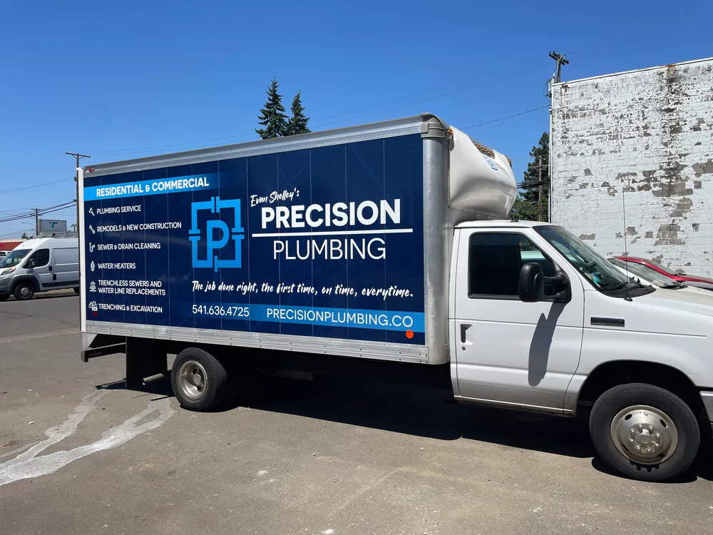 Precision Plumbing box truck on a job