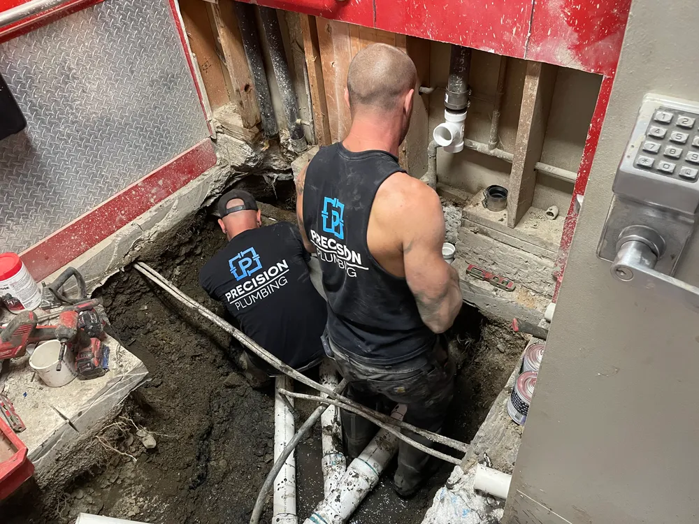 Hands-on sewer line repair in an open trench
