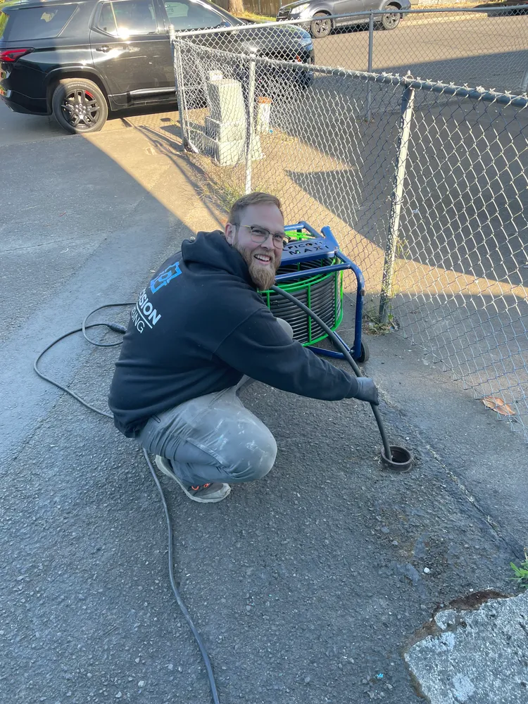 Technician working in an excavated hole beside a house