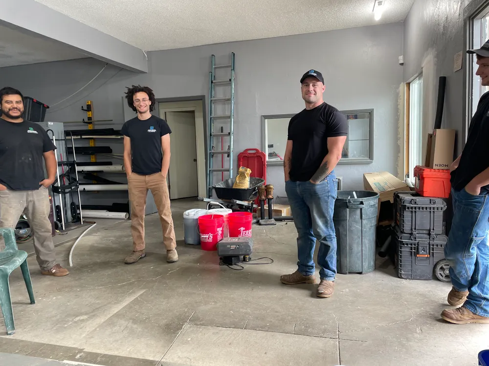 Precision Plumbing crew working in a residential yard