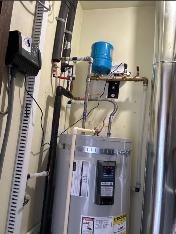 Blue water expansion tank connected to residential plumbing