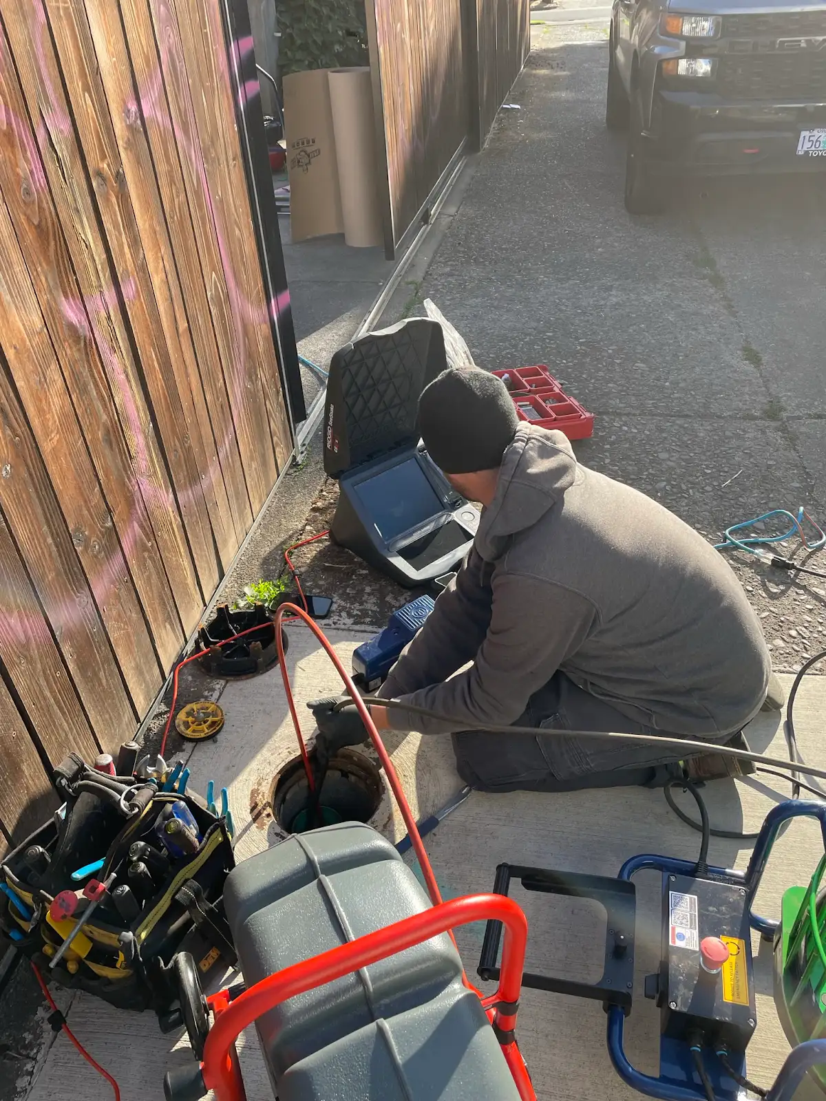 Precision Plumbing technician operating a sewer inspection camera