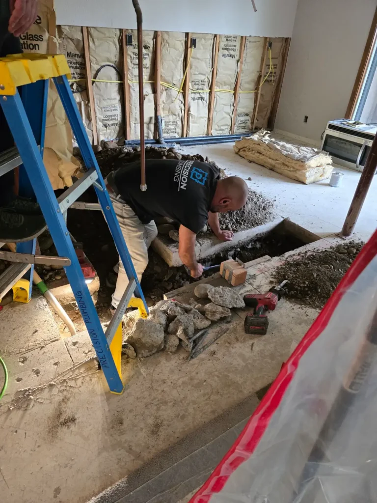 Interior excavation exposing a water line beneath a home for slab leak repair